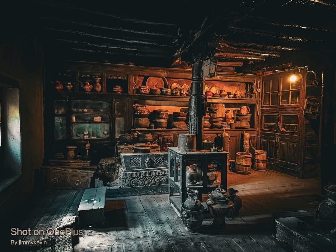 The old kitchen of the heritage house glowing in lamplight
